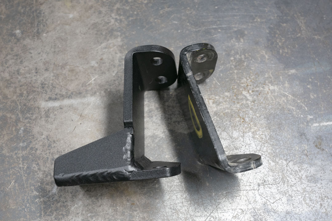 Front Jounce Reinforcement Bracket for Sprinter AWD (2023-Present), black metal, designed to support front suspension and prevent metal-to-metal contact during rough terrain driving.