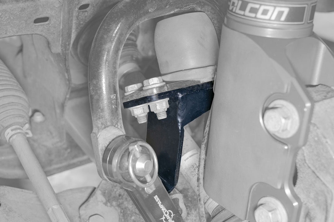 Close-up of the Front Jounce Reinforcement Bracket for Sprinter AWD (2023-Present), showcasing metal construction with bolts and nuts for enhanced suspension support.