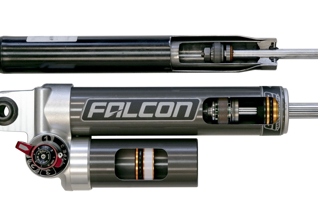 Close-up of STAGE 5 SYSTEM, 2 LIFT - SPRINTER 2WD (2019+ 2500 ONLY) by VAN COMPASS, showing detailed machine components and adjustable Falcon 3.3 rear shocks.