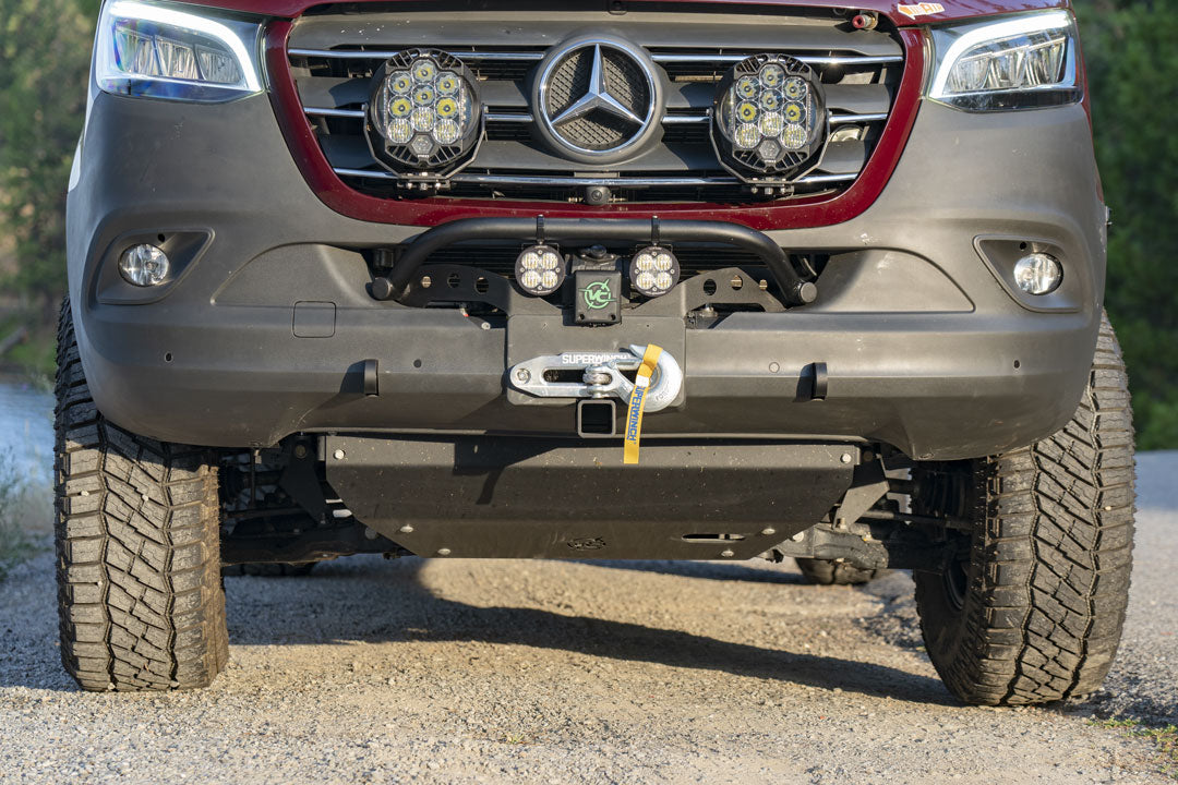 Front view of a Sprinter van showcasing the VAN COMPASS FRONT WINCH MOUNT WITH BULL BAR, highlighting its reinforced structure and integrated tow points.