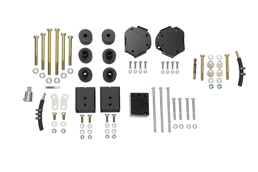 Front lift components for STAGE 6.3 DUALLY 2 LIFT SYSTEM - SPRINTER AWD (2023+ 3500) by VAN COMPASS, includes various black metal parts and bolts for enhanced van suspension and ground clearance.