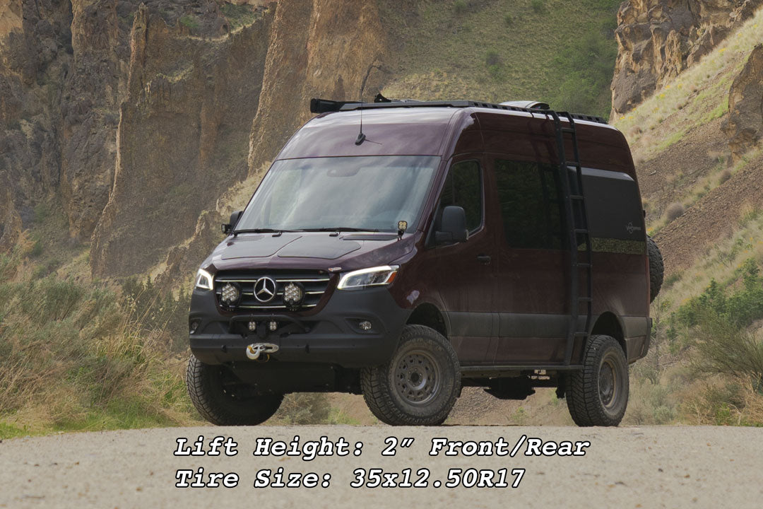Stage 5 System, 2 Lift - Sprinter 4x4 (2019-2022 2500) by Van Compass; van with enhanced suspension on a dirt road, highlighting raised stance and larger tires.