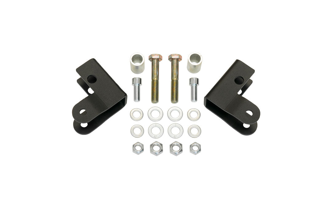REAR HIGH CLEARANCE SHOCK EXTENSION BRACKETS - TRANSIT (2013+) by VAN COMPASS: A collection of metal parts and nuts designed to improve under axle ground clearance and protect shocks.