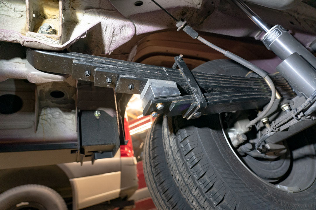 Close-up of OPTI-RATE REPLACEMENT LEAF SPRINGS for SPRINTER 3500 4x4 (PAIR) showing detailed tire and metal frame components.