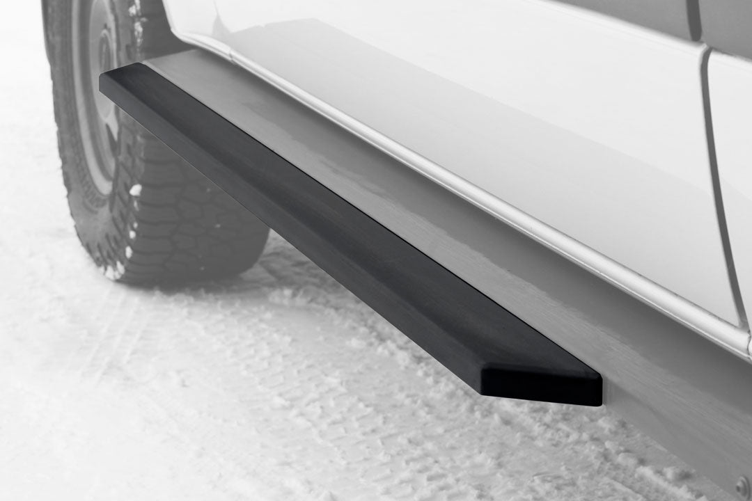 Rocker Guard Slider Door Step Extension for Sprinter 4x4, enhancing step area at the slider door, bolts onto the existing rocker guard, visible on a snowy ground.
