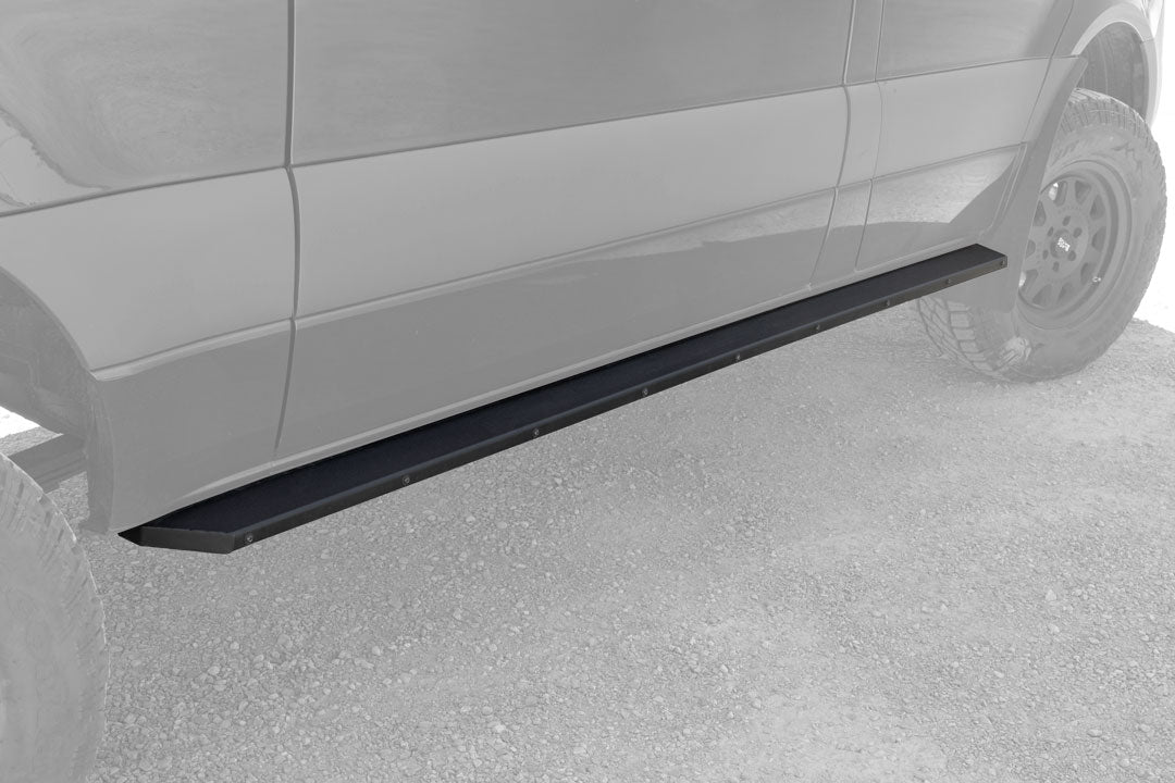 Close-up of a car tire and side featuring Van Compass Rocker Guards for Sprinter 4x4 (2015-2022, 144 wheelbase) providing protection and easy access.