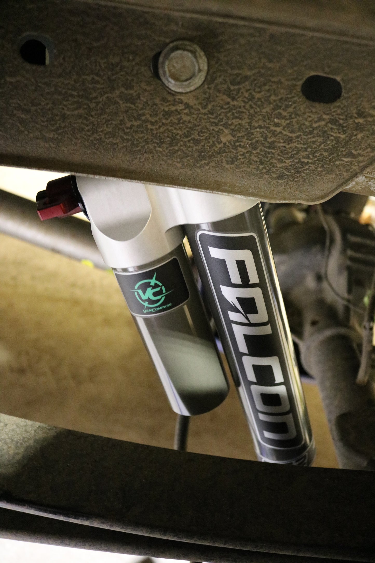Close-up of FALCON 3.3 SP2 Fast Adjust Rear Shocks - Transit (2013+) Pair, showcasing the adjustment knob, bolts, and detailed mechanical components.