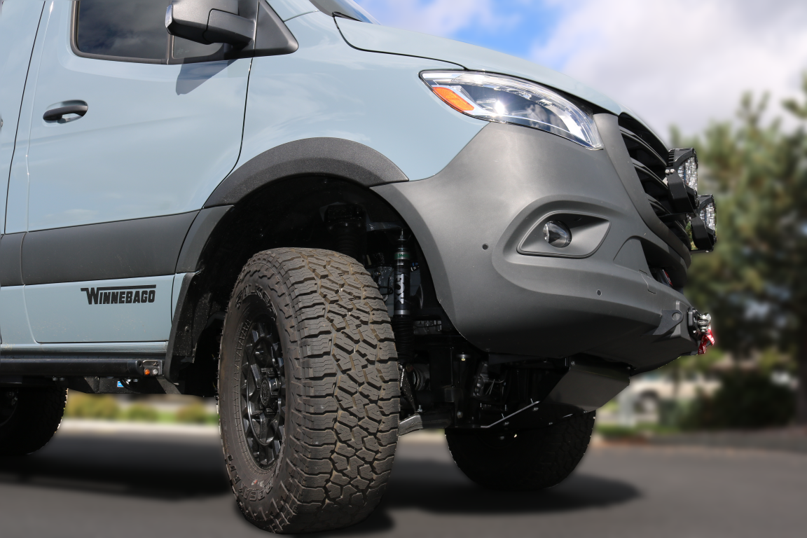 BIG TIRE MUDFLAP RELOCATION KIT - SPRINTER (2019+) by VAN COMPASS installed on a van, showcasing close-up views of tires, wheel openings, and fender modifications.