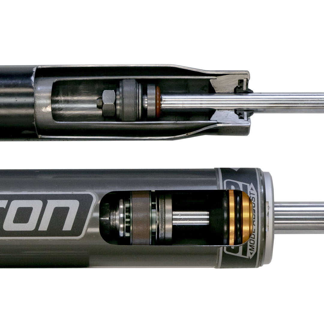 Close-up of the Falcon 2.1 Monotube Shocks, part of the Stage 1 System for Sprinter 2WD (2007+ 2500) by Van Compass, showcasing detailed metal components.