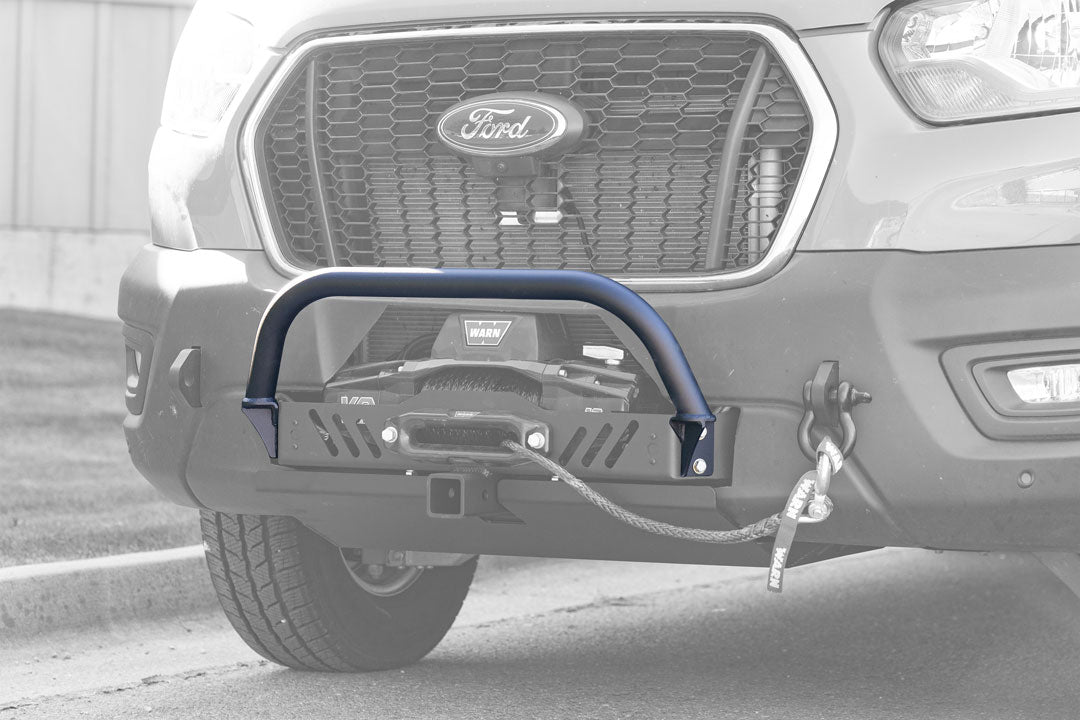 NERF BAR FOR HD WINCH MOUNT - TRANSIT (2015+) by VAN COMPASS: Close-up of a car bumper with a nerf bar attached, showcasing precision bent tubing and laser-cut flanges.