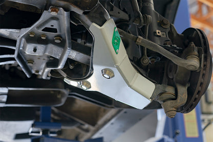 Close-up of VAN COMPASS Front lower control arm skid plates for Sprinter (2007+), showcasing robust aluminum build and precise tig welding for impact protection.