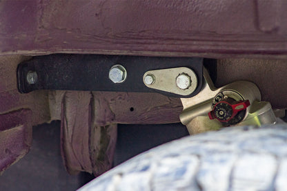 BAJA BRACKET REAR SHOCK MOUNT - SPRINTER (2007+ 2500 ONLY) by VAN COMPASS: Close-up of the metal bolt and nut on the shock mount bracket, highlighting its sturdy construction.