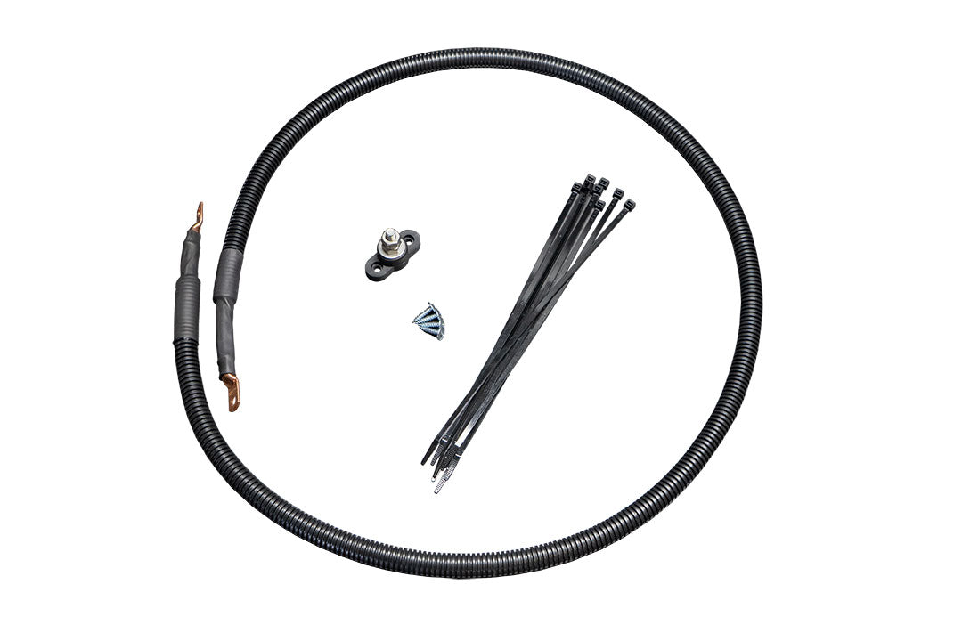 BIG POWER DISTRIBUTION KIT - SPRINTER (2019+) by VAN COMPASS features a black plastic tube with metal clips, screws, and a high-quality post terminal for winch wiring and electrical projects.