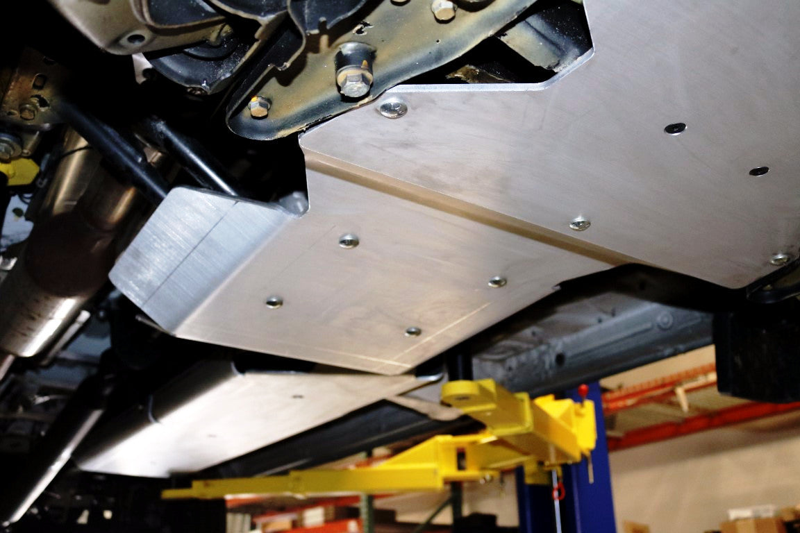 Transmission and Transfer Case Skid Plate for Sprinter 4x4 by Van Compass, showing a metal plate with bolts and screws designed for off-road protection.