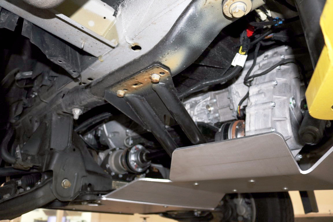 Close-up of the Van Compass Transmission/Transfer Case skid plate for Sprinter 4x4, showcasing its robust 1/4 thick aluminum construction for drivetrain protection.