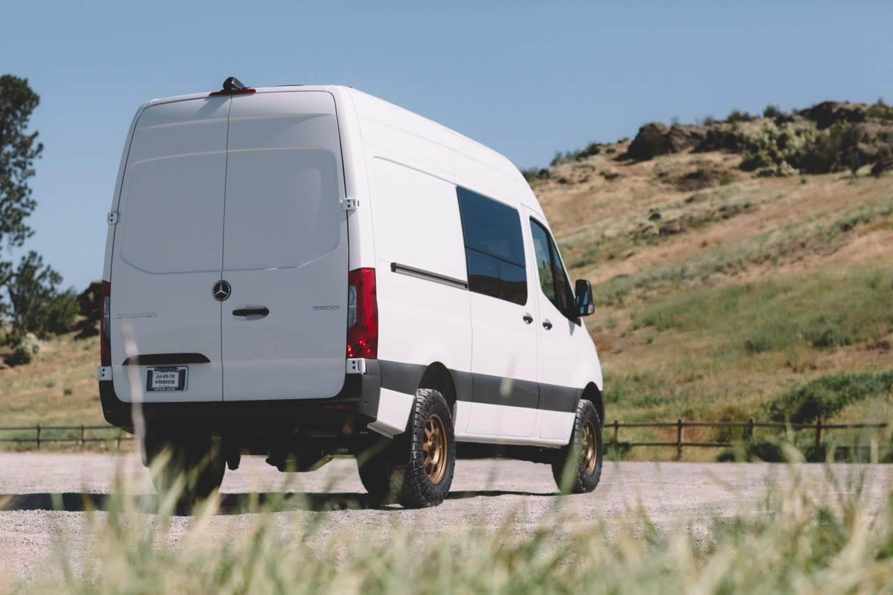 STRIKER 2 LIFT KIT (REAR ONLY) - SPRINTER 2WD (2019+) by VAN COMPASS shown on a white van parked on a road, highlighting improved rear suspension.