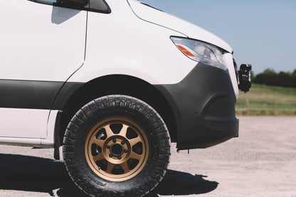 STRIKER 2 Lift Kit (Front Only) for Sprinter 2WD (2019-2022) by VAN COMPASS shown installed on a white van, highlighting enhanced tire clearance and off-road capability.