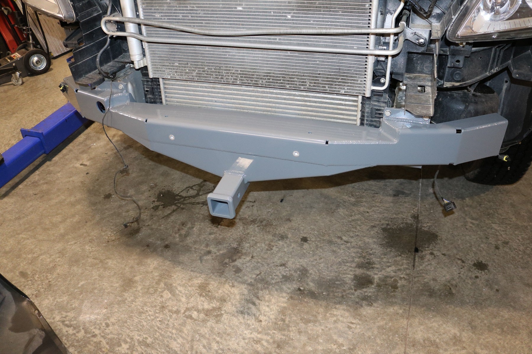 Front Receiver Hitch for Sprinter (2015+) by Van Compass, shown as a close-up of the sturdy bumper and integrated receiver hitch for bike racks or winches.