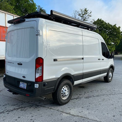 White van with black roof rack parked on pavement, equipped with the Stage 1 Topo 2.0 System for improved ride quality and stability by Van Compass.