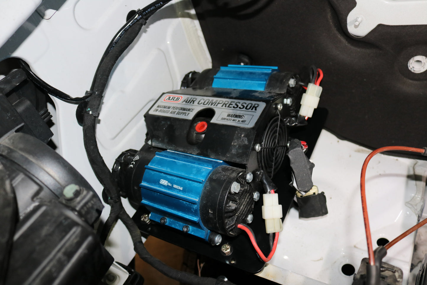 Van Compass Air System Mount for 2019+ Mercedes Sprinter, featuring a black and blue air compressor installed in an engine bay for versatile air needs.